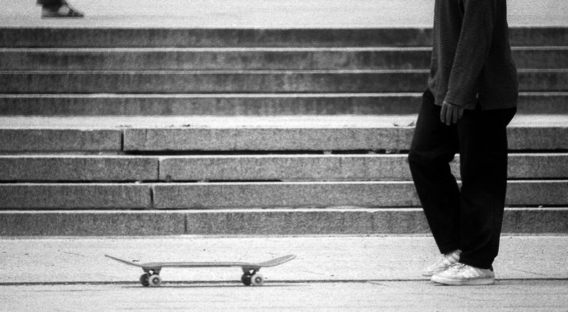 A photograph of a man with a skateboard at the lookout atop Mont Royal in Montreal. Taken with a Canon F1New camera and a Canon FD 100-300mm lens with CatLabs 320 film.