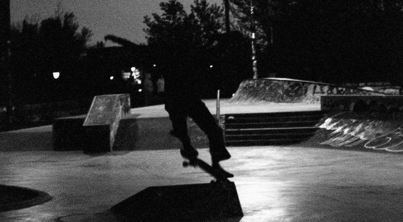 A photograph of a skateboarder doing a trick late at night in Montreal's Mile End. Canon F1New camera using CatLabs 320 black and white film.