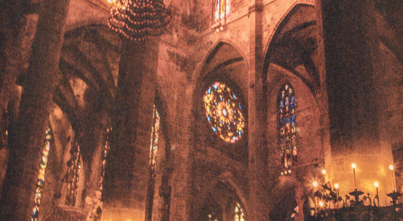 A photograph of the light shining through colored glass at the Catedral-Basílica de Santa María de Mallorca in Palma de Mallorca.