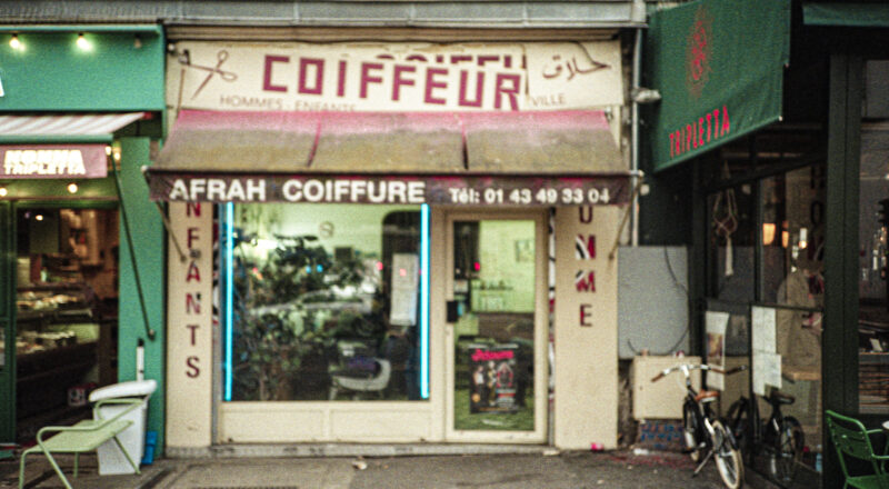 A photograph of a hairdresser storefront in Paris.