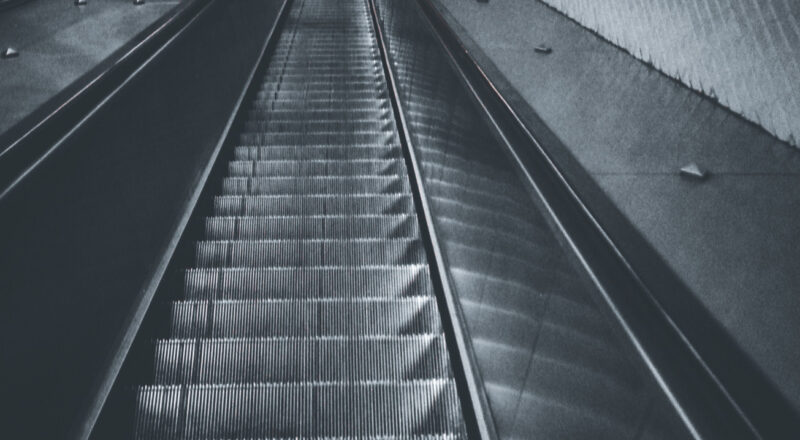 A picture taken at the top of an escalator at a Metro station in Paris. Taken with a Nikon L35AF using Fujicolor Colorplus 400 film.