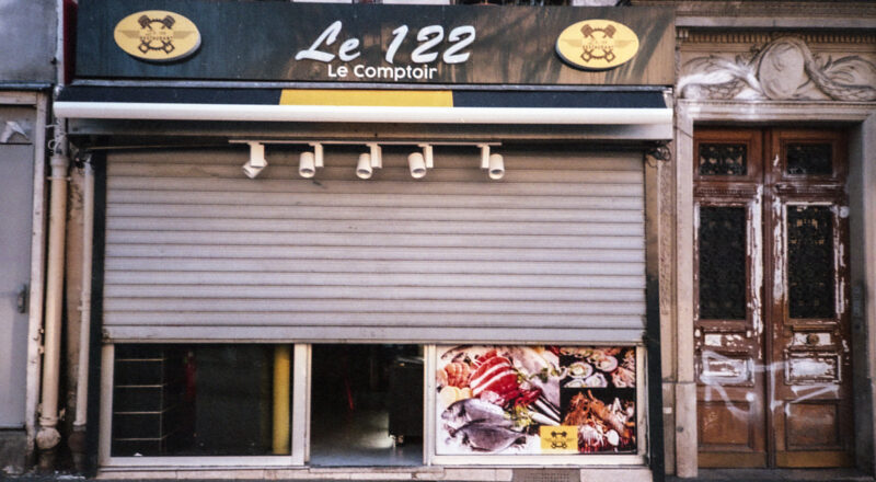 A photograph of poissonerie and restaurant, Le 12a2 in Paris on Boulevard Belleville. Taken with a Nikon L35AF using Fujicolor Colorplus 400 film.