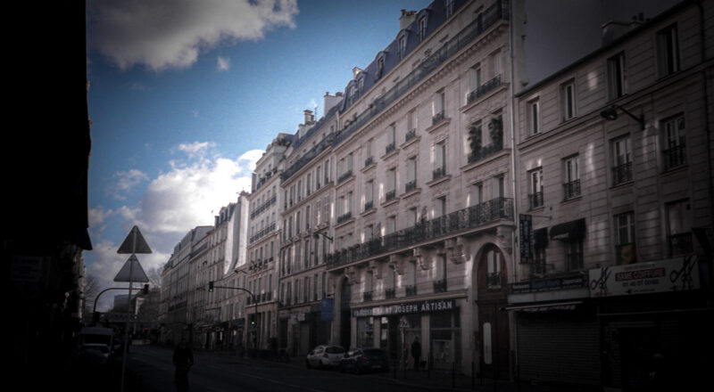 A photograph of a row of apartment buildings in Paris. Taken with a Nikon L35AF using Fujicolor Colorplus 400 film.