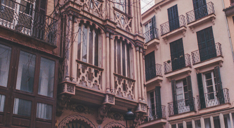 A photograph of buildings in a shopping district of Palma de Mallorca.
