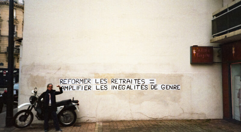 A photograph of a woman and a motorcycle next to graffiti in Paris. Taken with a Nikon L35AF and Fujicolor 400 film.