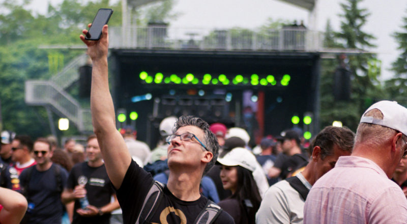 A photograph of a fan during the qualifying round of the 2023 Canadian Grand Prix in Montreal at the Circuit Jacques Villeneuve. Taken with a Canon F1New film camera using Kodak Ektar 100 Professional film.