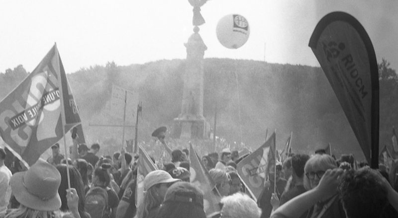 A photograph from a union rally in support of Quebec service workers including teachers and nurses near the Sir George-Etienne Cartier Monument in Montreal during the summer of 2023. Taken with a Canon F1New using CatLabs 320 film.
