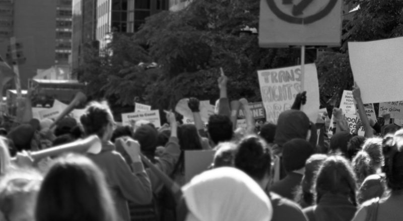 A photograph of a middle finger being presented to anti-trans hatemongers from the anti-LGBTQ+ rally in Montreal in 2023 of the resistance. Taken with a Canon F1New using CatLabs 320 film.