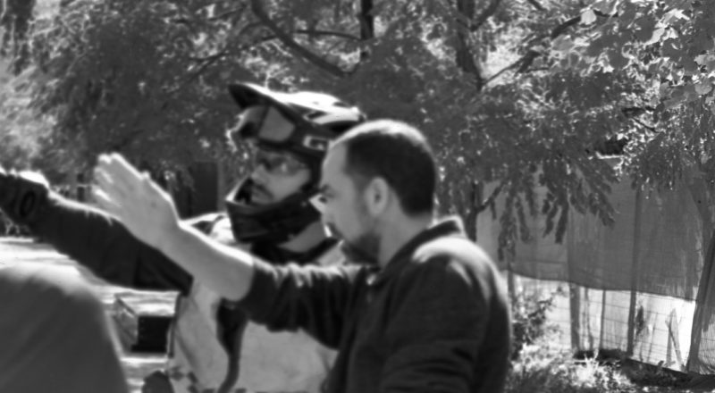 A photograph of a cop showing an anti-trans hatemonger where to go from the anti-LGBTQ+ rally in Montreal in 2023 of the resistance. Taken with a Canon F1New using CatLabs 320 film.