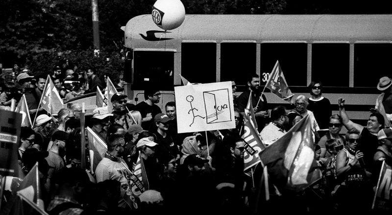 A photograph from a union rally in support of Quebec service workers including teachers and nurses near the Sir George-Etienne Cartier Monument in Montreal during the summer of 2023. Taken with a Canon F1New using CatLabs 320 film.
