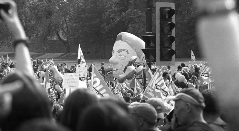A photograph from a union rally in support of Quebec service workers including teachers and nurses near the Sir George-Etienne Cartier Monument in Montreal during the summer of 2023. Taken with a Canon F1New using CatLabs 320 film.