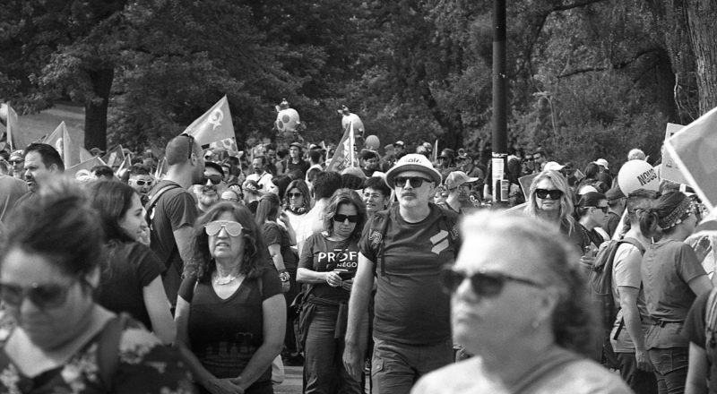 A photograph of protestors from a union rally in support of Quebec service workers including teachers and nurses near the Sir George-Etienne Cartier Monument in Montreal during the summer of 2023. Taken with a Canon F1New using CatLabs 320 film.