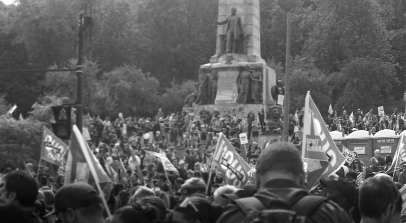 A photograph of protestors from a union rally in support of Quebec service workers including teachers and nurses near the Sir George-Etienne Cartier Monument in Montreal during the summer of 2023. Taken with a Canon F1New using CatLabs 320 film.