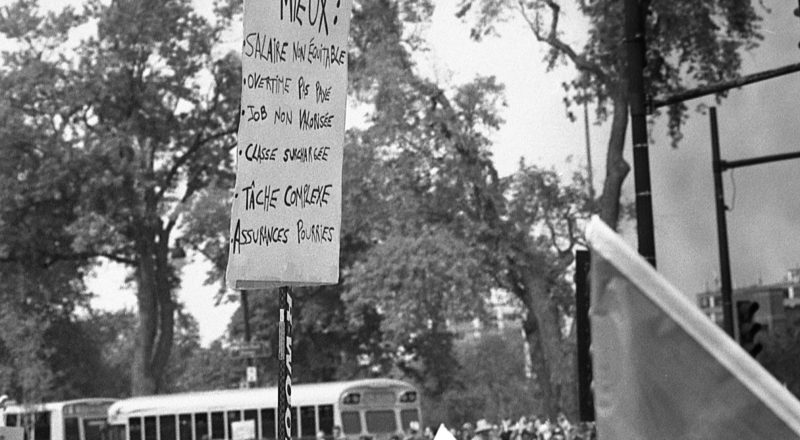 A photograph of protestors from a union rally in support of Quebec service workers including teachers and nurses near the Sir George-Etienne Cartier Monument in Montreal during the summer of 2023. Taken with a Canon F1New using CatLabs 320 film.