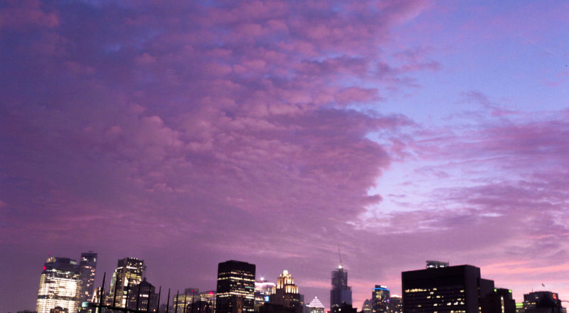 The skyline of Montreal photographed at the golden hour with a dramatic sky in the background using a Mamiya M645 1000S and Kodak Portra 800 film.